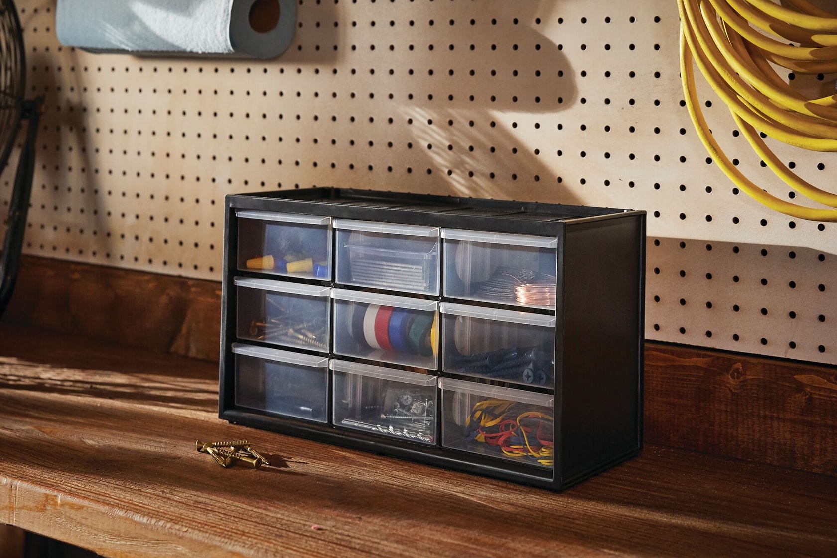 Large 9 Drawer Bin System containing multiple small items placed on top of wooden work table.