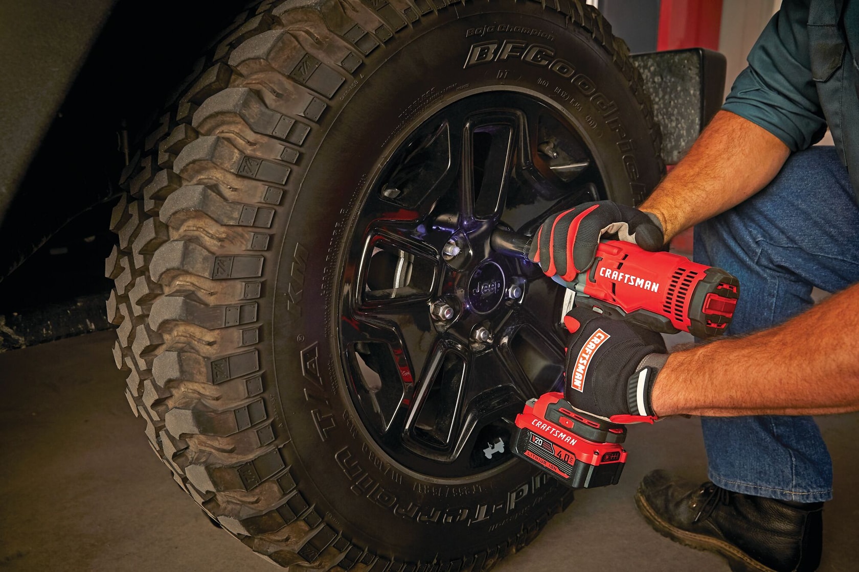 Cordless half inch impact wrench kit 1 battery being used to tighten lug nut.