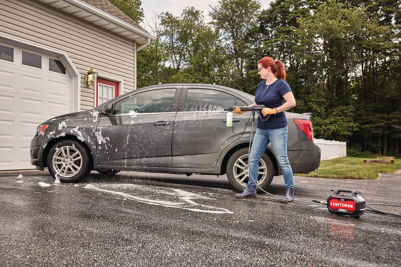 1700 pound per square inch electric compact cold water pressure washer being used by a person.