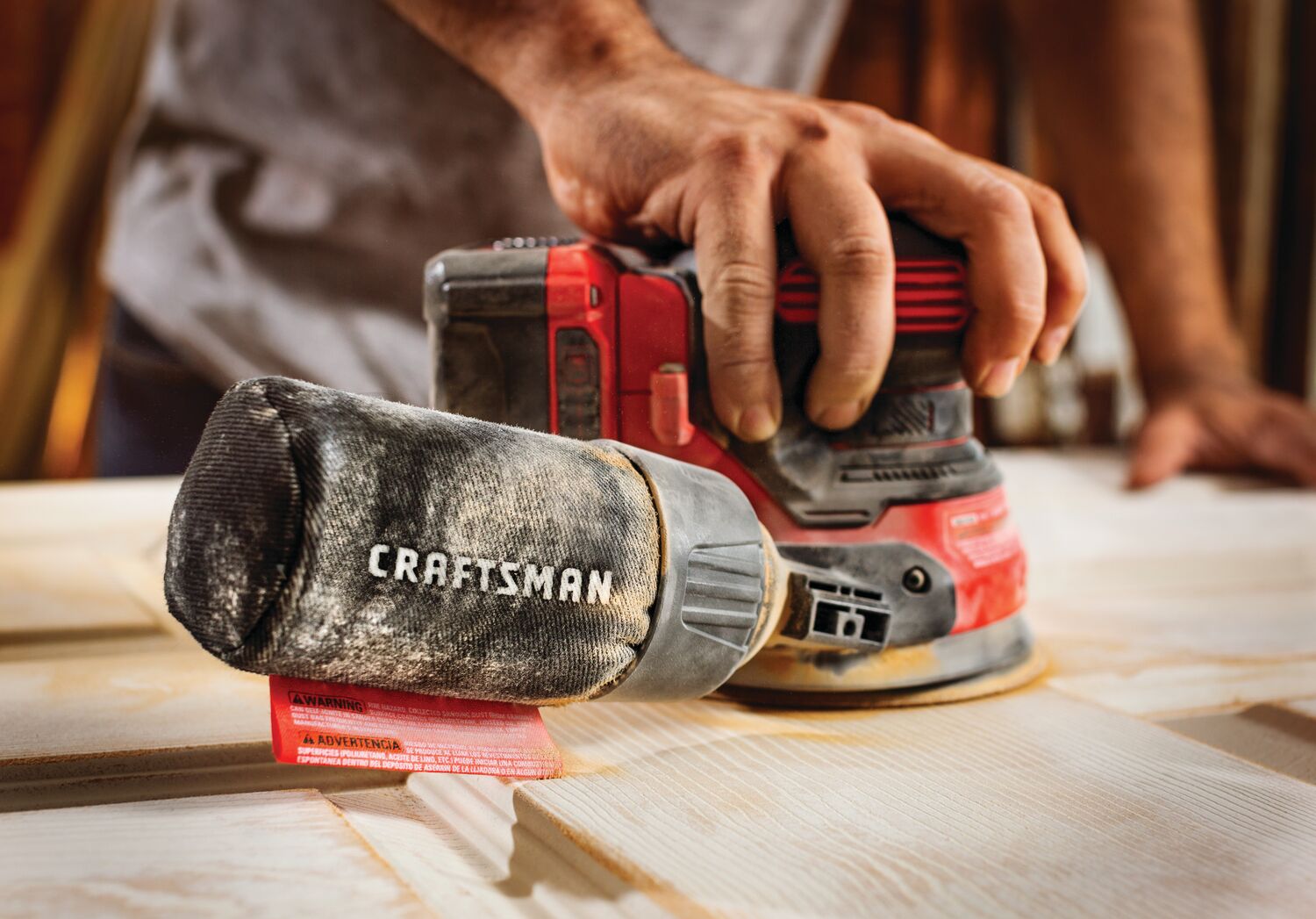 20 volt cordless random orbit sander being used .